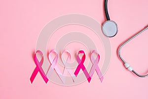 Breast Cancer Awareness, Pink Ribbon with Stethoscope on pink background for supporting people living and illness. Woman