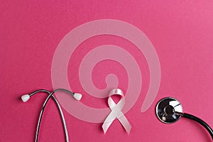 Breast cancer awareness symbol. Pink ribbon and stethoscope on p