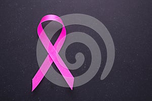 Breast Cancer concept : Pink ribbon symbol of breast cancer on b