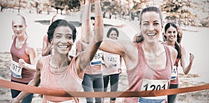 Breast cancer participants crossing finish line at race