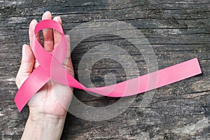 Breast cancer pink awareness ribbon symbolic bow color raising support campaign on people living life with female tumor breast