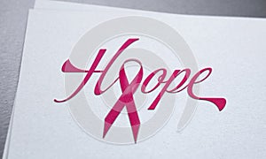 Breast cancer pink ribbon concept on white paper