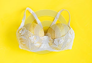 Breast enlargement concept, white bra with two melons photo