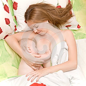 Breast feeding baby in bed