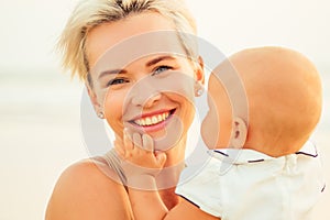 Breast-feeding on breast-feeding concept. beautiful woman with baby on the summer beach at sunset