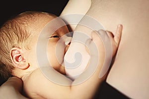 Breast-feeding. mother feeds newborn baby with breast