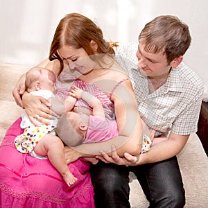 Breast-feeding twin babies at home.