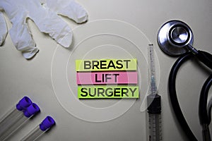 Breast Lift Surgery text on Sticky Notes. Top view isolated on office desk. Healthcare/Medical concept