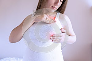 Breast pain self exam. Young pregnancy woman examining breast for signs lumps. Breast self exam. Health, medicine and