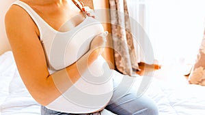 Breast self exam pregnancy woman check. Happy young pregnant woman self exam. Cancer self check. Healthy lifestyle