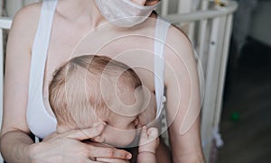 Breastfeeding baby eating milk from mother`s breast and bottle. Concept - breastfeeding and motherhood