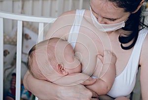 Breastfeeding baby eating milk from mother`s breast and bottle. Concept - breastfeeding and motherhood