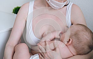 Breastfeeding baby eating milk from mother`s breast and bottle. Concept - breastfeeding and motherhood