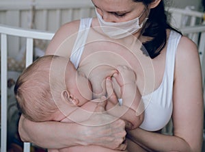 Breastfeeding baby eating milk from mother`s breast and bottle. Concept - breastfeeding and motherhood