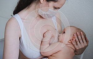 Breastfeeding baby eating milk from mother`s breast and bottle. Concept - breastfeeding and motherhood
