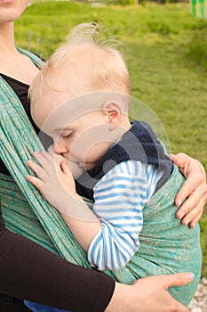 Breastfeeding in baby sling outdoors