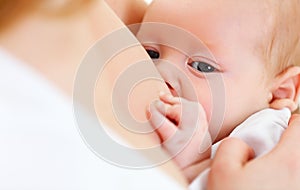 Breastfeeding. mother holding newborn in embrace and breastfeed