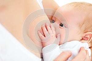 Breastfeeding. mother holding newborn in embrace and breastfeed