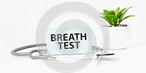 BREATH TEST word on notebook, stethoscope and green plant