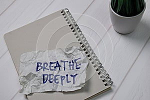 Breathe Deeply write on sticky notes isolated on office desk photo