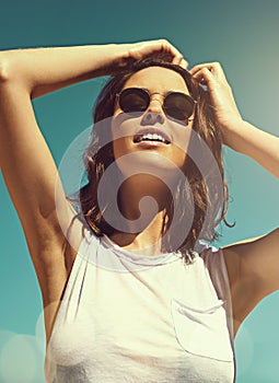 Breathe the salty air. an attractive young woman enjoying a day on the beach.