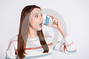 Breathing in bronchospasm attack spray lady wear striped pullover isolated white background photo