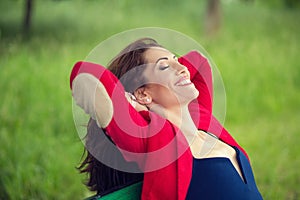 Breathing, enjoying nature fresh air, life happiness. Beautiful young girl smiling, thinking, daydreaming, holding hands above