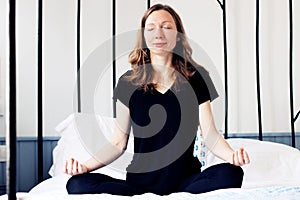 breathing exercises Business woman yoga meditation on bed relaxed in lotus pose