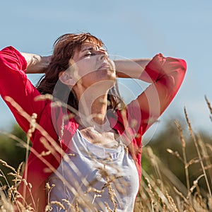 Breathing young senior woman in harmony with nature