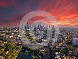 A breathtaking aerial shot of downtown Los Angeles with skyscrapers lush green trees, small buildings and homes