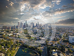 A breathtaking aerial shot of downtown Los Angeles with skyscrapers lush green trees, small buildings and homes