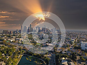 A breathtaking aerial shot of downtown Los Angeles with skyscrapers lush green trees, small buildings and homes