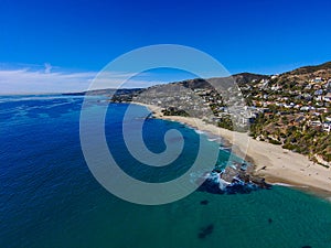 A breathtaking aerial shot of the vast blue ocean water along the coastline with sandy beaches