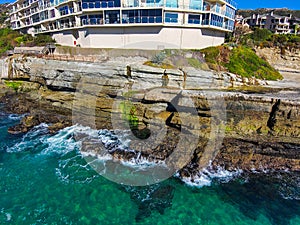 A breathtaking aerial shot of the vast blue ocean water along the coastline with sandy beaches