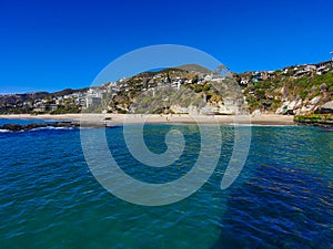 A breathtaking aerial shot of the vast blue ocean water along the coastline with sandy beaches