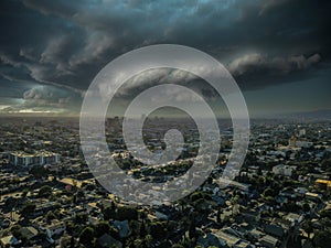 A breathtaking aerial shot of vast miles of buildings in the cityscape at sunset powerful storm clouds in Los Angeles