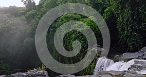 Breathtaking aerial view of a lush waterfall in a forest