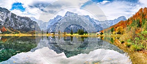 Breathtaking autumn scene of sunny morning on Almsee lake. Poppular travell destination