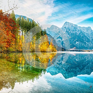 Breathtaking autumn scene of sunny morning on Almsee lake. Poppular travell destination