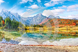 Breathtaking autumn scene of sunny morning on Almsee lake. Poppular travell destination