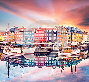 Breathtaking beautiful scenery with boats in the famous Nyhavn in Copenhagen, Denmark at sunrise. Exotic amazing places. Popular
