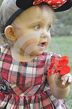 Breathtaking Beauty Baby Girl Holding A Flower