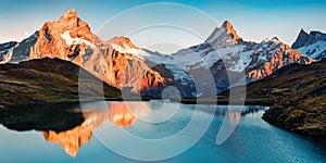 Breathtaking evening panorama of Bachalp lake/Bachalpsee, Switzerland. Exciting autumn sunset in Swiss alps, Grindelwald, Bernese