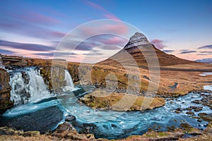 Breathtaking landscape with waterfall near Kirkjufellsfoss and Kirkjufell hills in Iceland