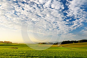 Breathtaking lansdcape of Austrian countryside on sunset. Dramatic sky over idyllic green fields of Anstrian Central Alps on autum