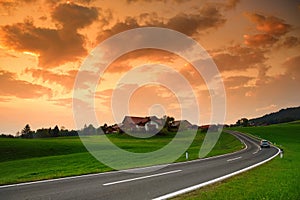 Breathtaking lansdcape of Austrian countryside on sunset. Dramatic sky over idyllic green fields of Anstrian Central Alps on autum