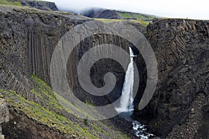 Breathtaking Litlanesfoss waterfall at east of Iceland. Waterfall is framed by basalt columns