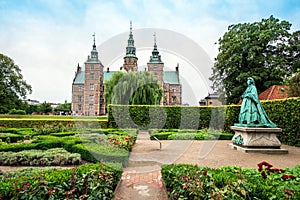 Breathtaking magical landscape with statue of Queen Caroline Amalie in the park of famous Rosenborg Castle in Copenhagen, Denmark