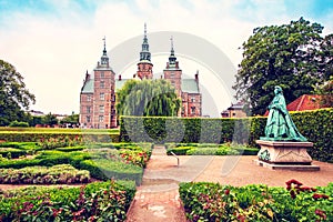 Breathtaking magical landscape with statue of Queen Caroline Amalie in the park of famous Rosenborg Castle in Copenhagen, Denmark