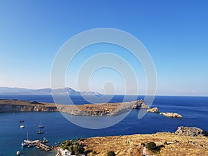 Breathtaking magnificent drone view of calm blue sea and small boats sailing on it on amazing sunny day.